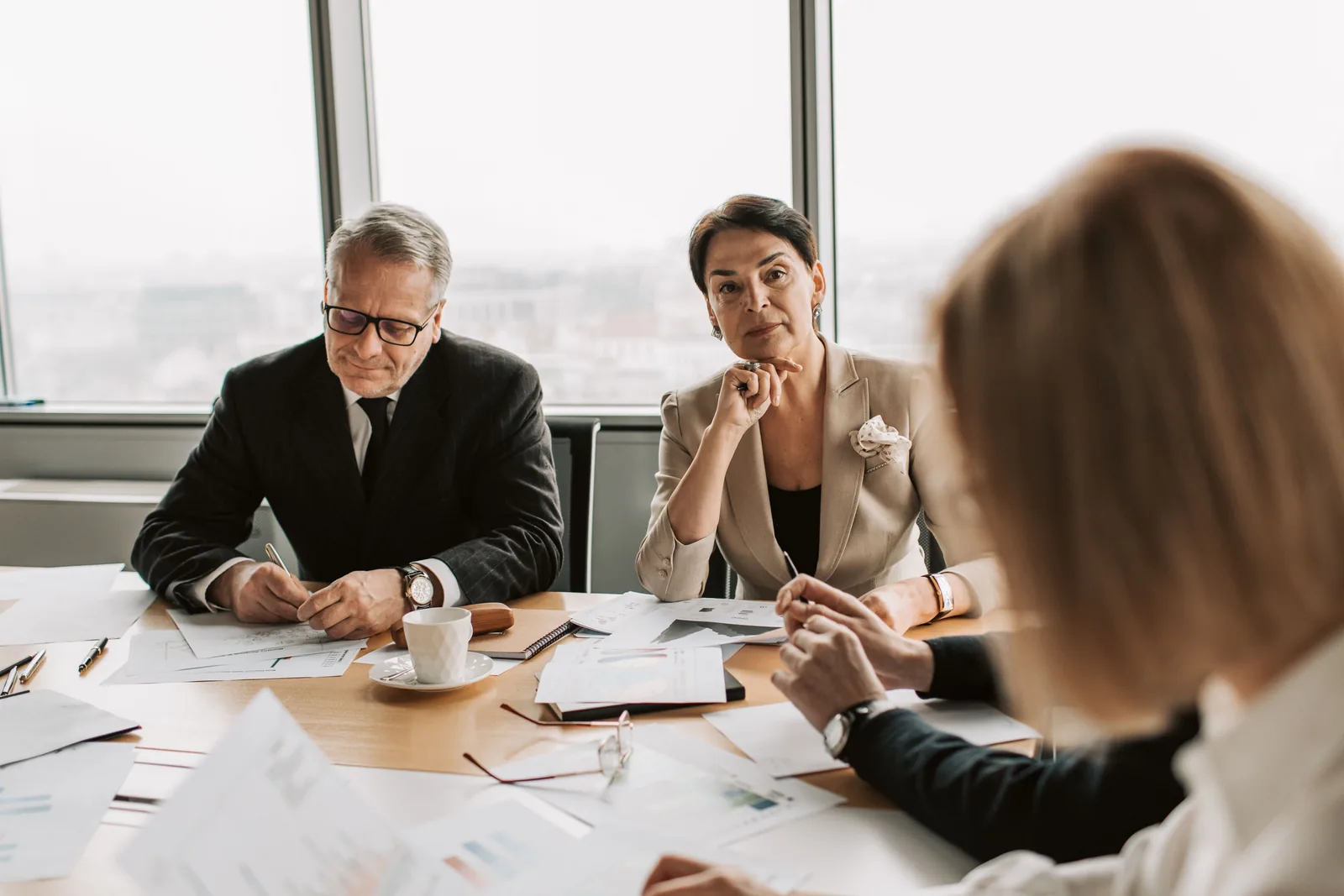 Senior leaders in a focused boardroom discussion