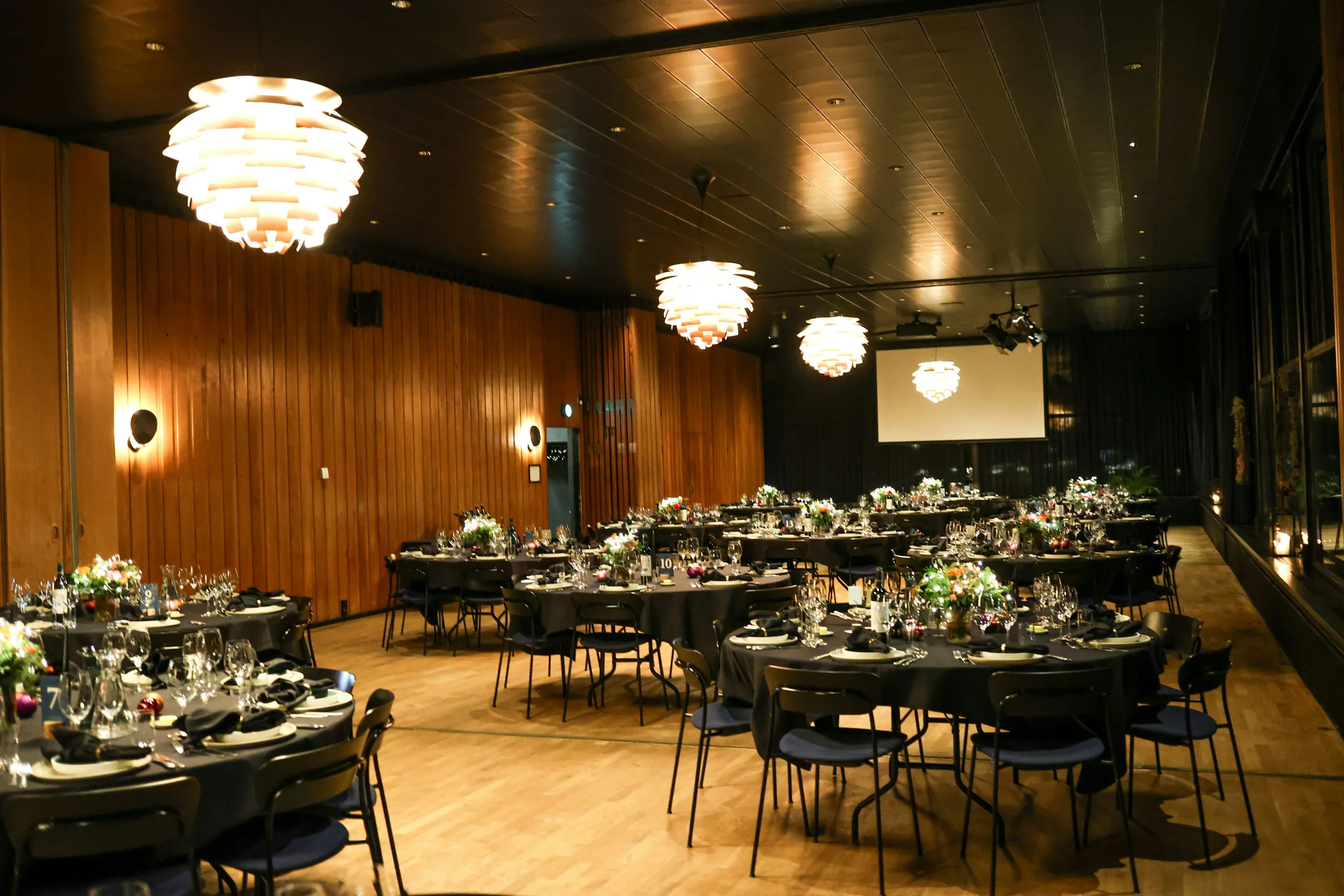 An event hall set with round dinner tables
